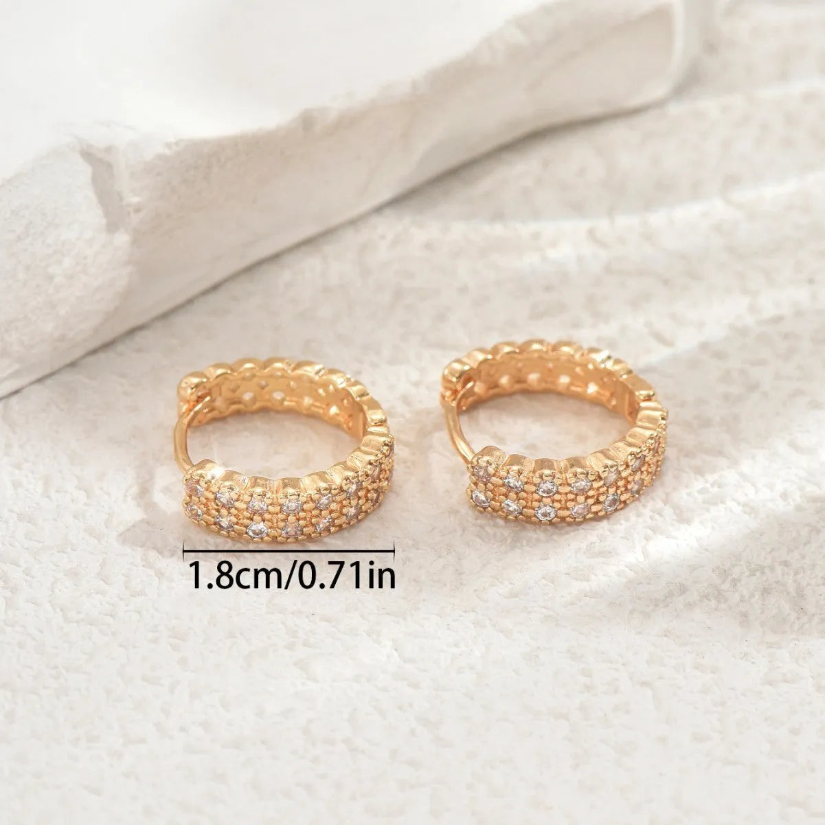 Geometric pattern copper ear studs in colour DE20288 showing round, dot, and ring design elements.