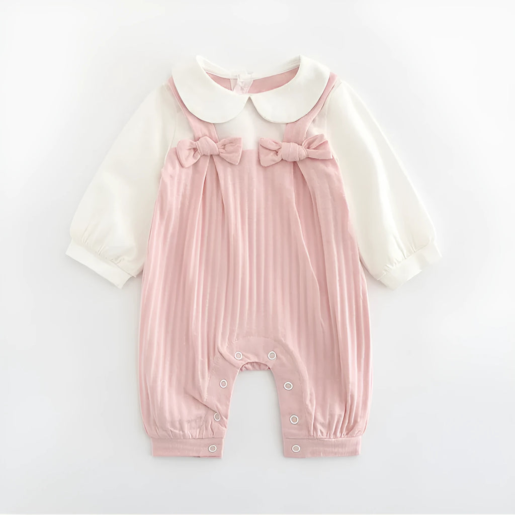 Pink baby girl's embroidered long sleeve cotton jumpsuit on a hanger