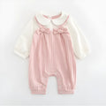 Pink baby girl's embroidered long sleeve cotton jumpsuit on a hanger