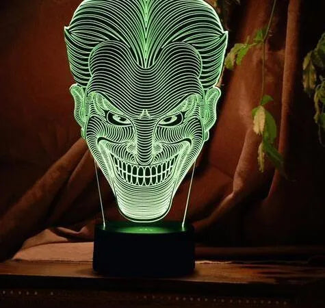 USB-powered 3D acrylic LED table lamp with remote control on a desk, displaying colourful gradient lighting.
