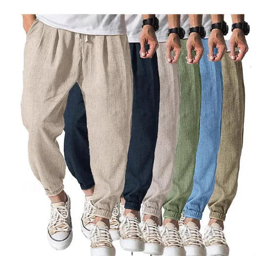 Man wearing loose light-coloured cotton trousers with elasticated ankle cuffs, showing front and side views.