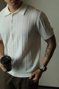 A man's loose-fit solid colour polyester pullover t-shirt on a hanger, shown in black and white colour options.