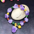 Natural shaped purple amethyst bead bracelet with a fu character charm for women.