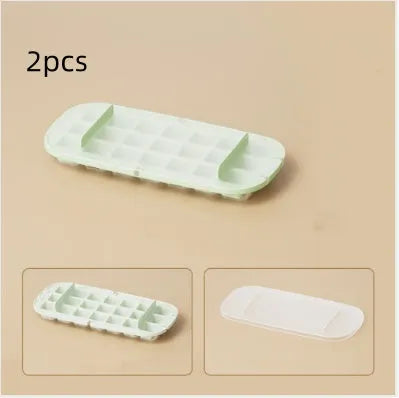 Food-grade high-capacity ice cube tray grid in blue with included ice shovel stored in dedicated slot.