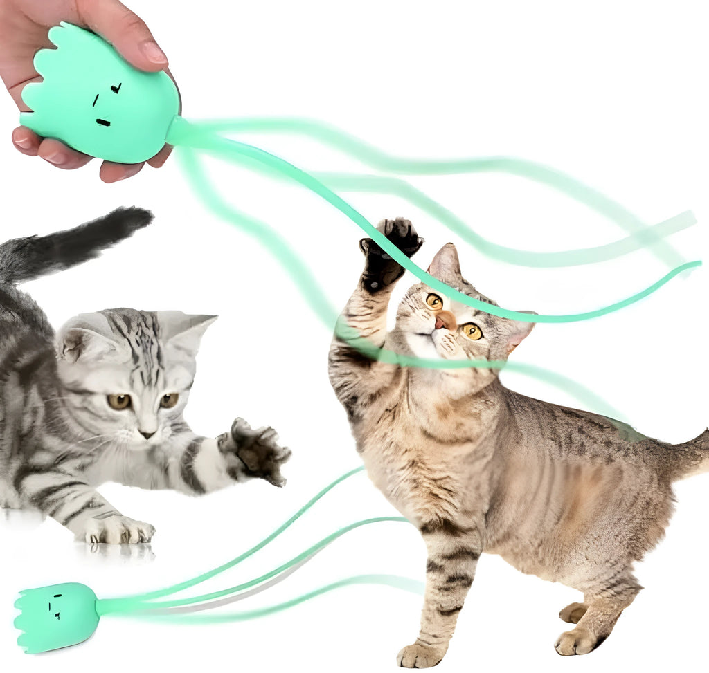 Green automatic cat wand toy with silicone tail on floor for indoor cat play