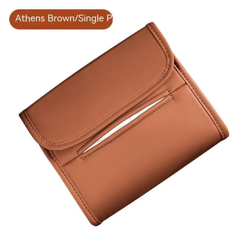Brown leather car tissue box with elastic band, shown mounted on a car sun visor.