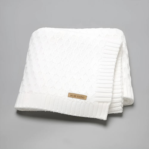 Solid colour acrylic infant blanket with textured lines, shown in a choice of five colours.