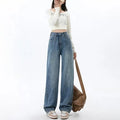 Woman wearing retro blue high-waisted wide-leg jeans with a straight-leg cut.