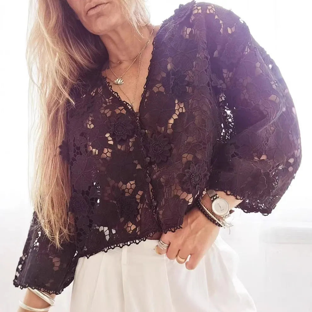 Black loose V-neck cardigan with white three-dimensional lace flowers on the front and hollow long sleeves.
