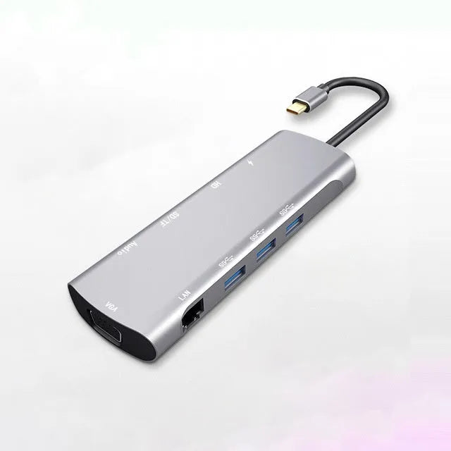 Grey aluminium USB-C docking station with HDMI, VGA, USB 3.0, and PD charging ports.