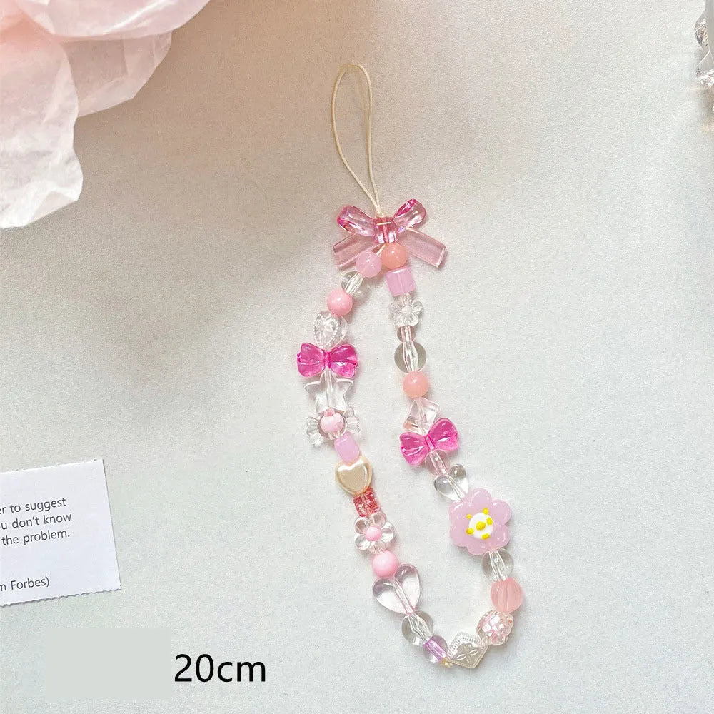 Blue, pink, and yellow beaded flower phone lanyard on a white background.