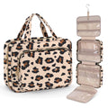 Large capacity black travel wash bag for cosmetics next to makeup items