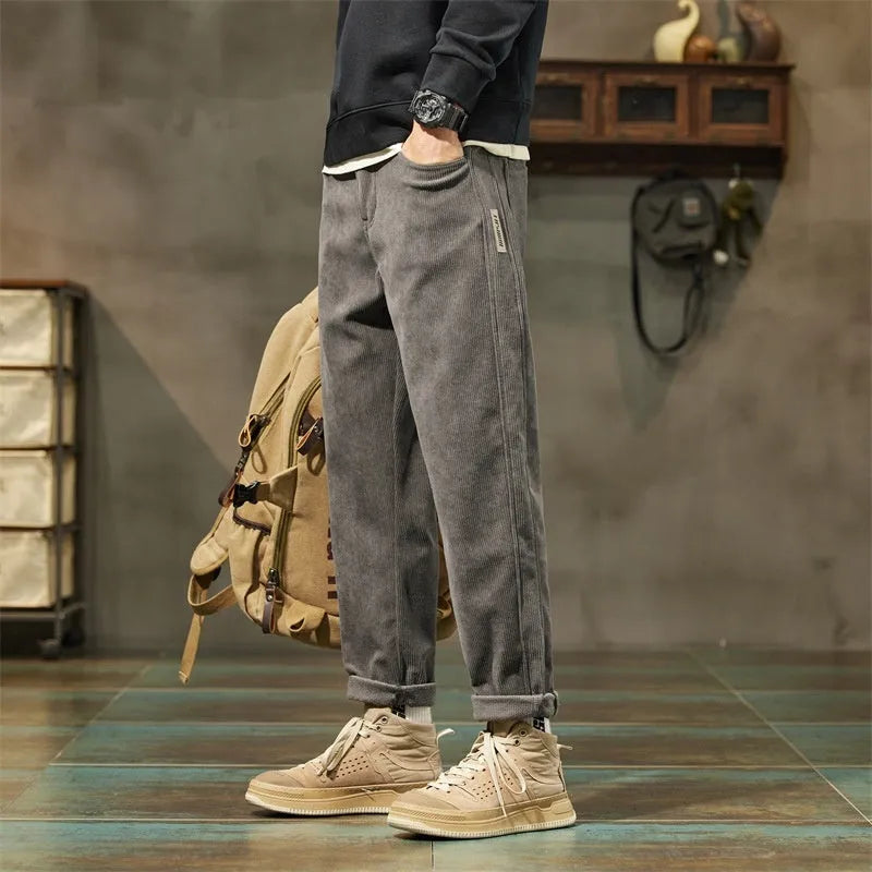 Men's army green corduroy casual trousers with a tapered straight-leg fit on a mid waist.