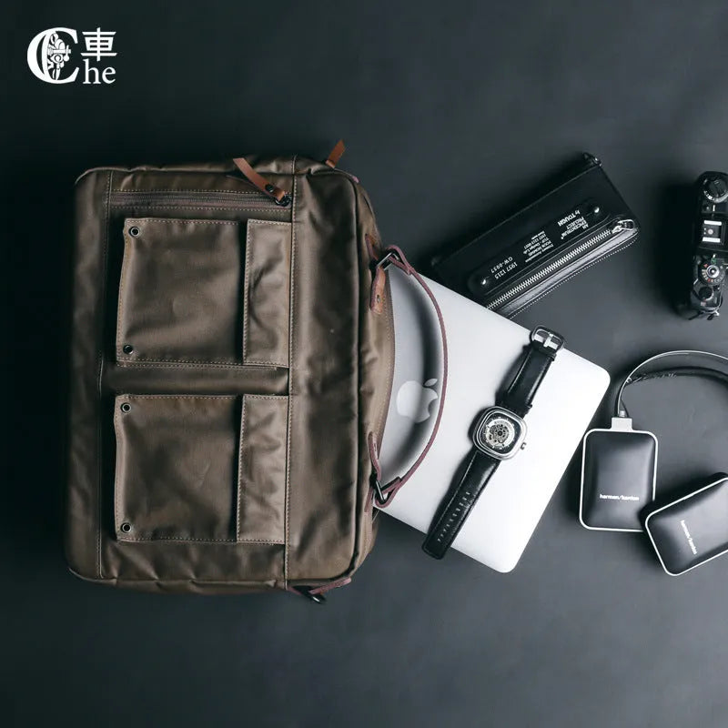 Dpark black laptop shoulder bag for a 14 or 15 inch business laptop, showing front pocket and strap.