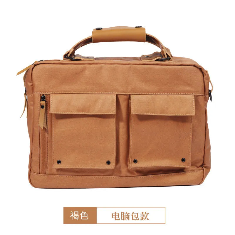 Dpark black laptop shoulder bag for a 14 or 15 inch business laptop, showing front pocket and strap.