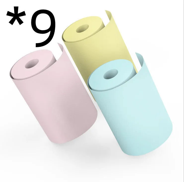 Bluetooth mini thermal photo printer in pink with USB cable and paper rolls on a white background