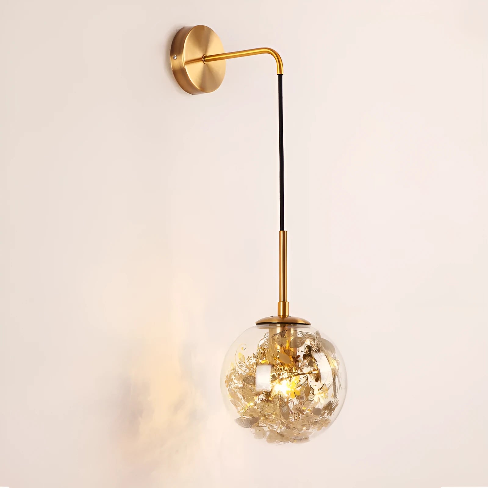 Modern glass wall lamp with golden flower finish and warm white LED light.