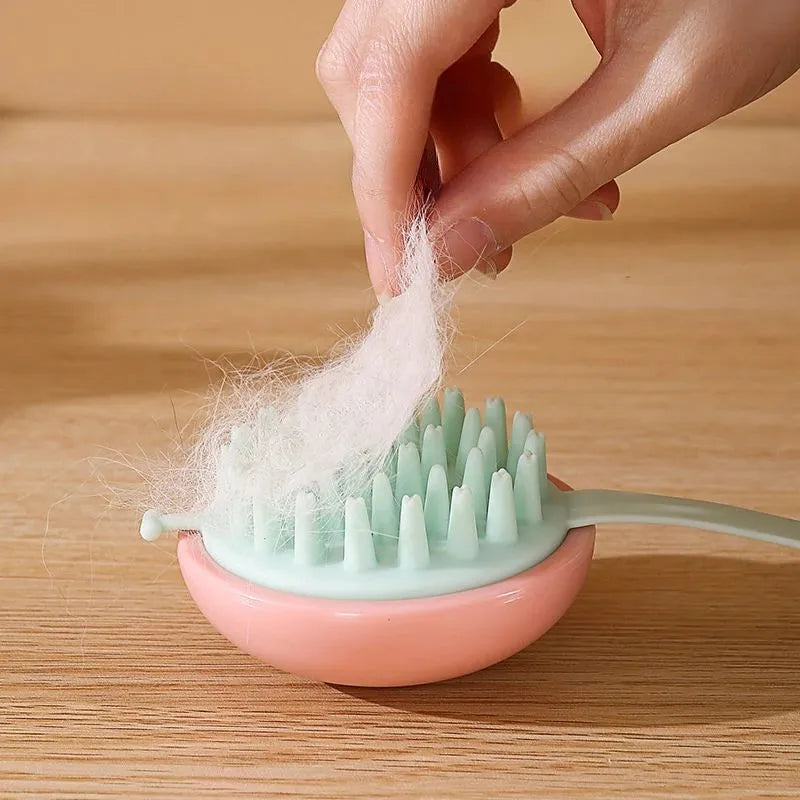 Blue silicone pet bathing brush with soft bristles for massaging and scrubbing cats and dogs.