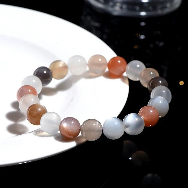 Natural colourful moonlight bracelet with 8mm moonstone beads on a wrist.