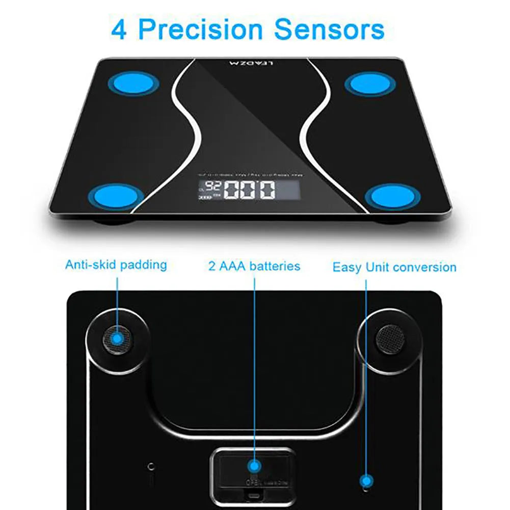 Black electronic digital body scale on a floor with a 180kg maximum capacity.