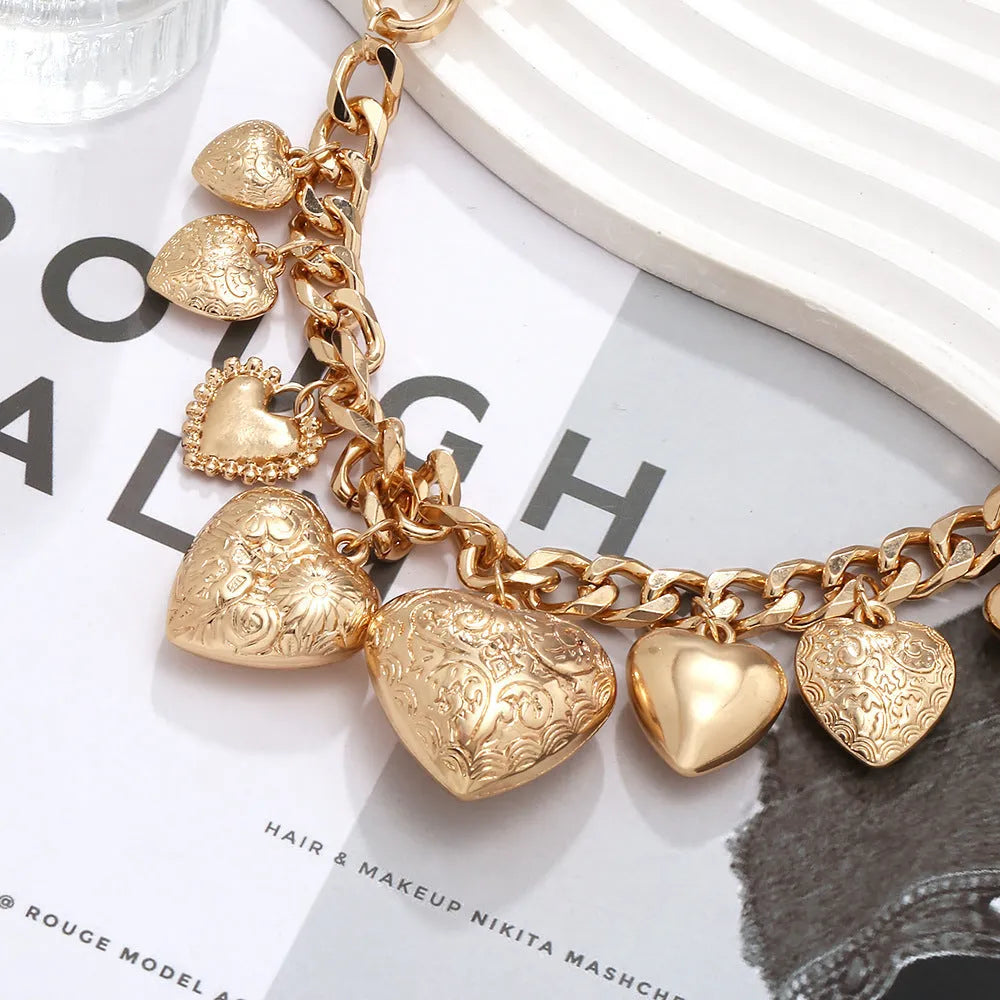Exaggerated carved heart pendant necklace on metal chain with adjustable 41-50cm length in gold finish