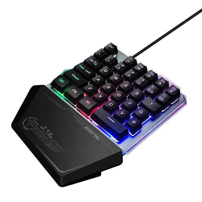 Black one-handed mechanical gaming keyboard with RGB backlit keys on a desk.