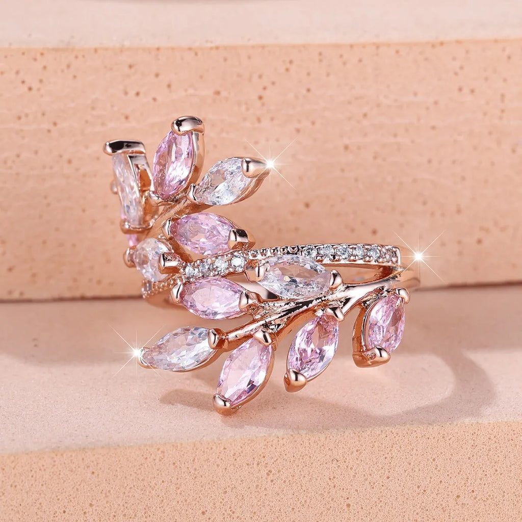 Adjustable open-ended leaf-shaped ring with zirconia stones on a copper band.