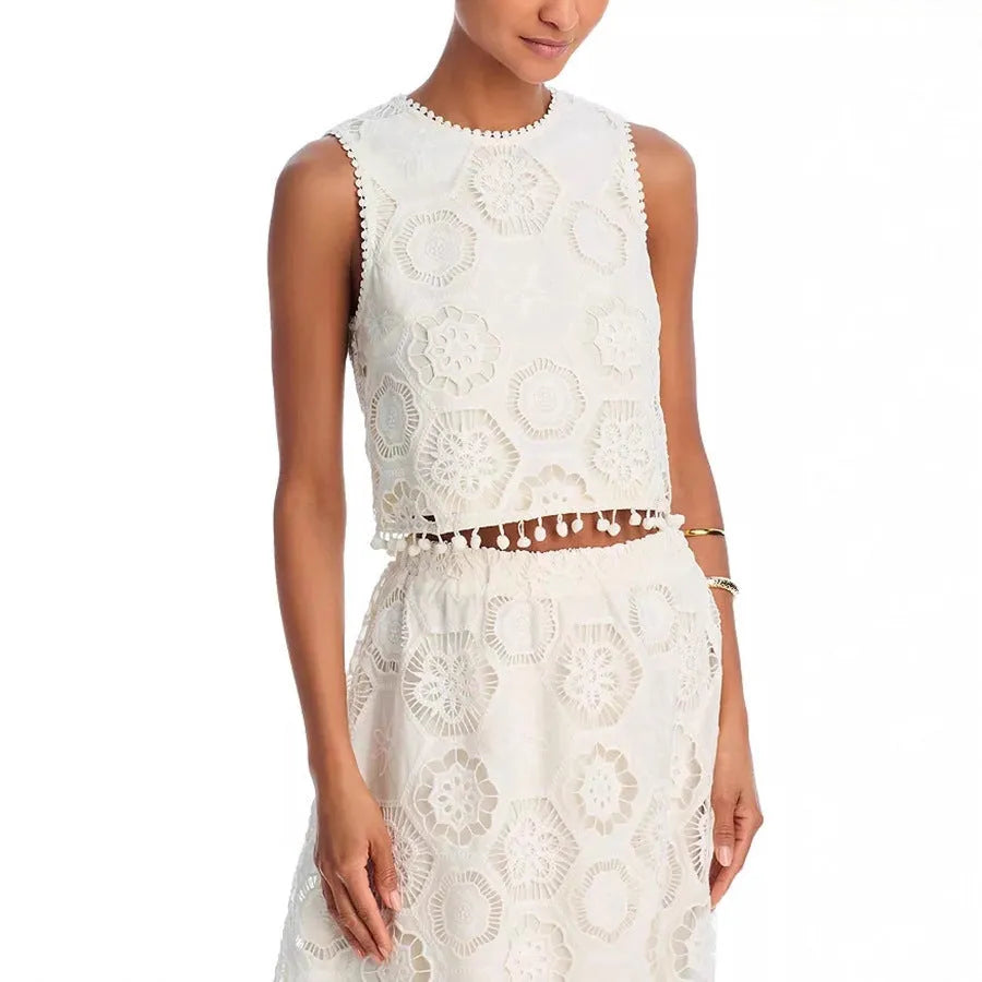 White women's sleeveless top and embroidered long skirt suit set on a hanger.