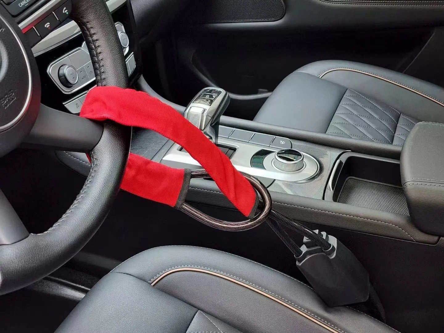 Red iron wire rope car steering wheel lock with key for General Motors vehicles.