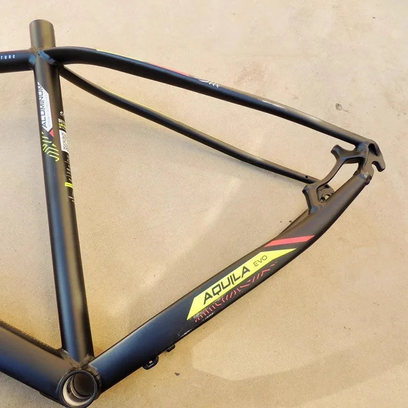 Black green aluminium mountain bike frame for 29-inch wheels with disc brake mount and internal cable routing ports.