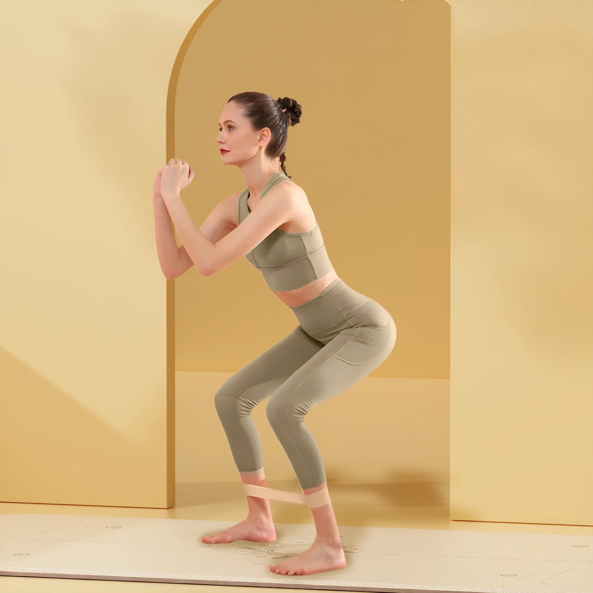 Four elastic resistance bands in green, beige, orange, and pink colours representing 30, 20, 15, and 10 lbs resistance levels