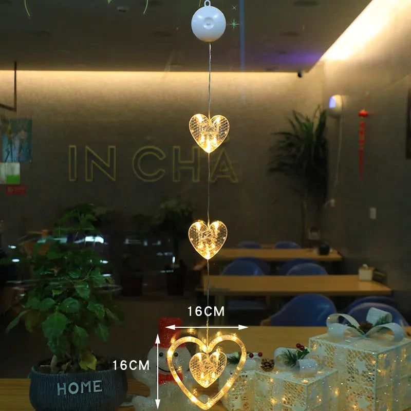 Set of three battery-powered LED Christmas pendant lights with suction cups, showing star, tree, and deer designs.