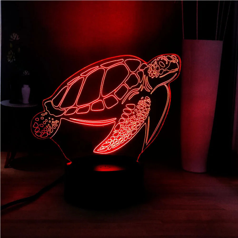 A glowing 3D acrylic turtle-shaped LED night light on a surface, showing its detailed sculpture and soft coloured light.