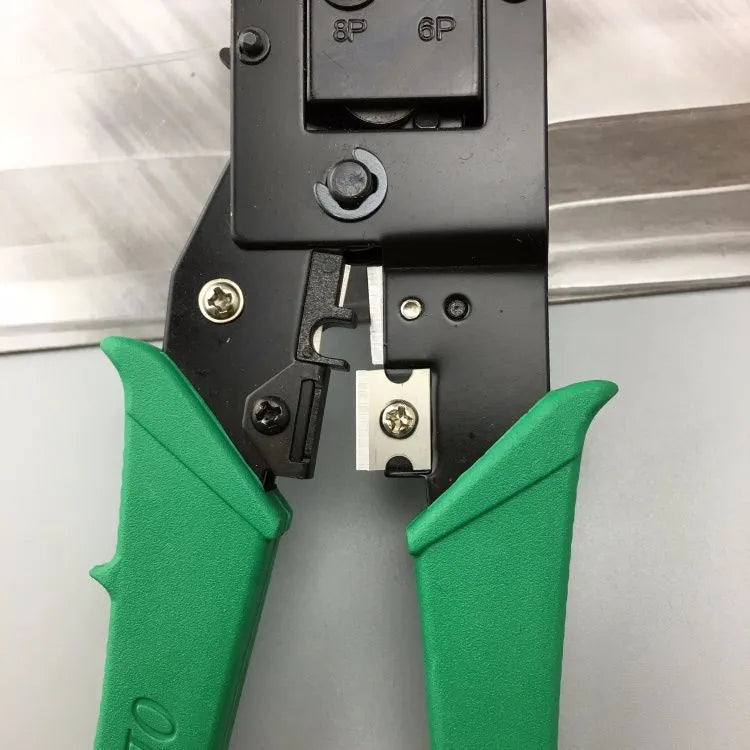 Green dual-purpose crystal head net pliers with tool steel crimping jaws on a white background