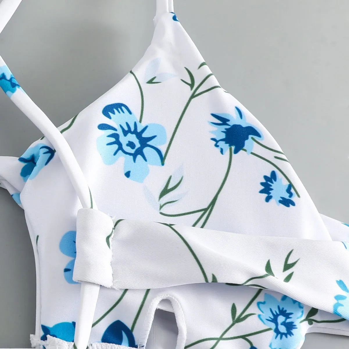 Women's floral print swimsuit set with triangle tie-neck top and matching shorts