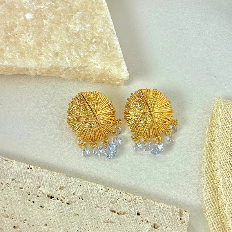 Geometric gold metal hoop earrings with round design elements