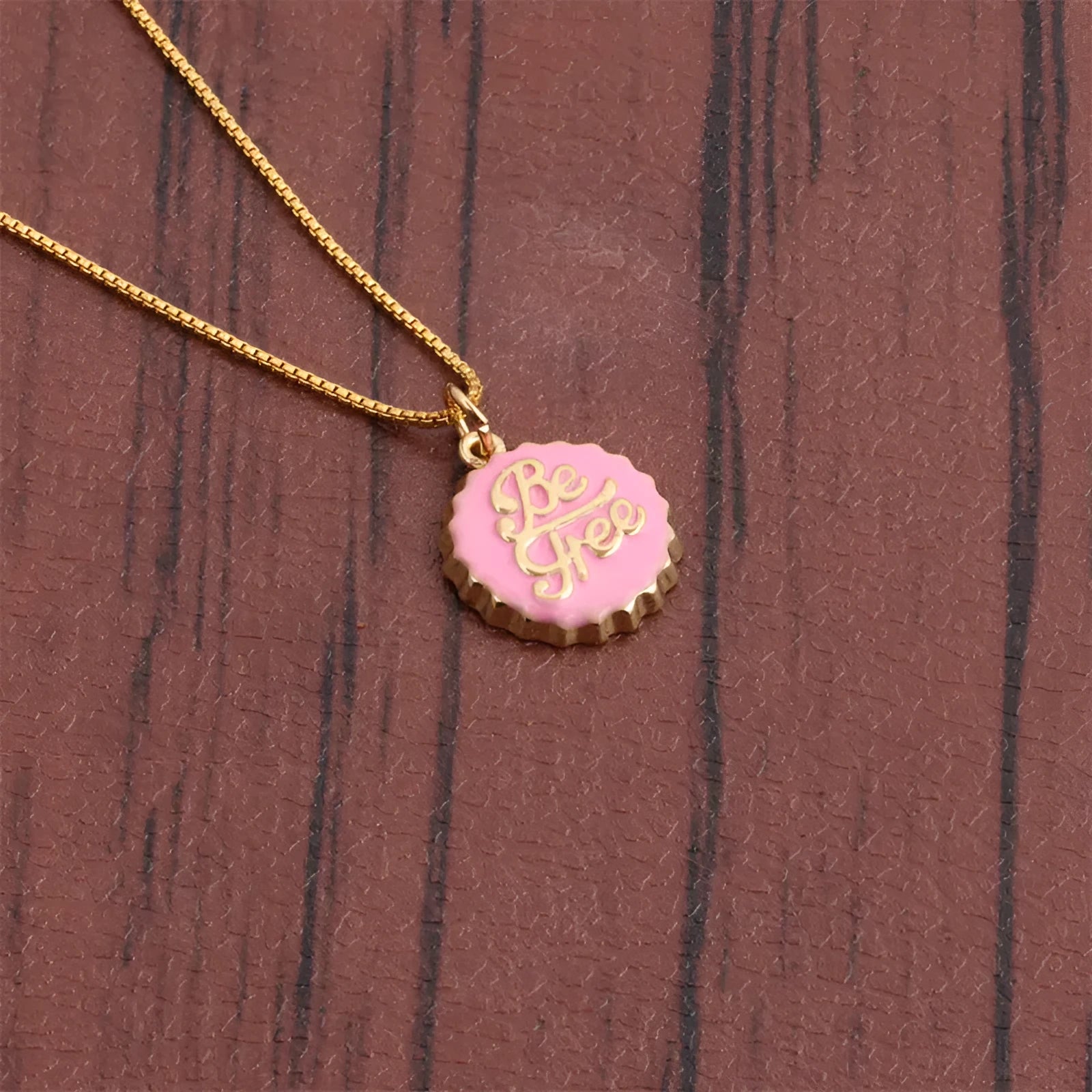 Copper bottle cap pendant necklace with gold plating on a 40cm chain, shown in multiple colour options.