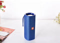 Cloth-covered wireless Bluetooth speaker in multiple colours showing front with speaker grilles