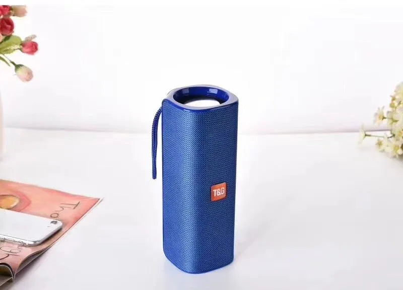 Cloth-covered wireless Bluetooth speaker in multiple colours showing front with speaker grilles