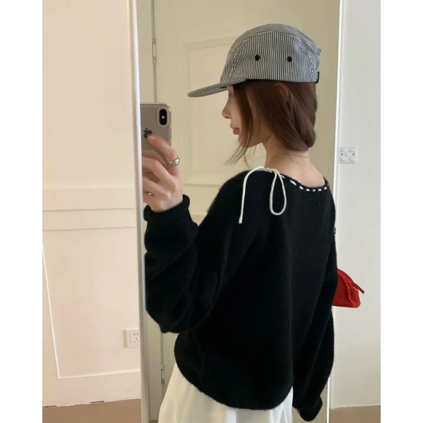 Grey loose-fit women's knit pullover top on a hanger.