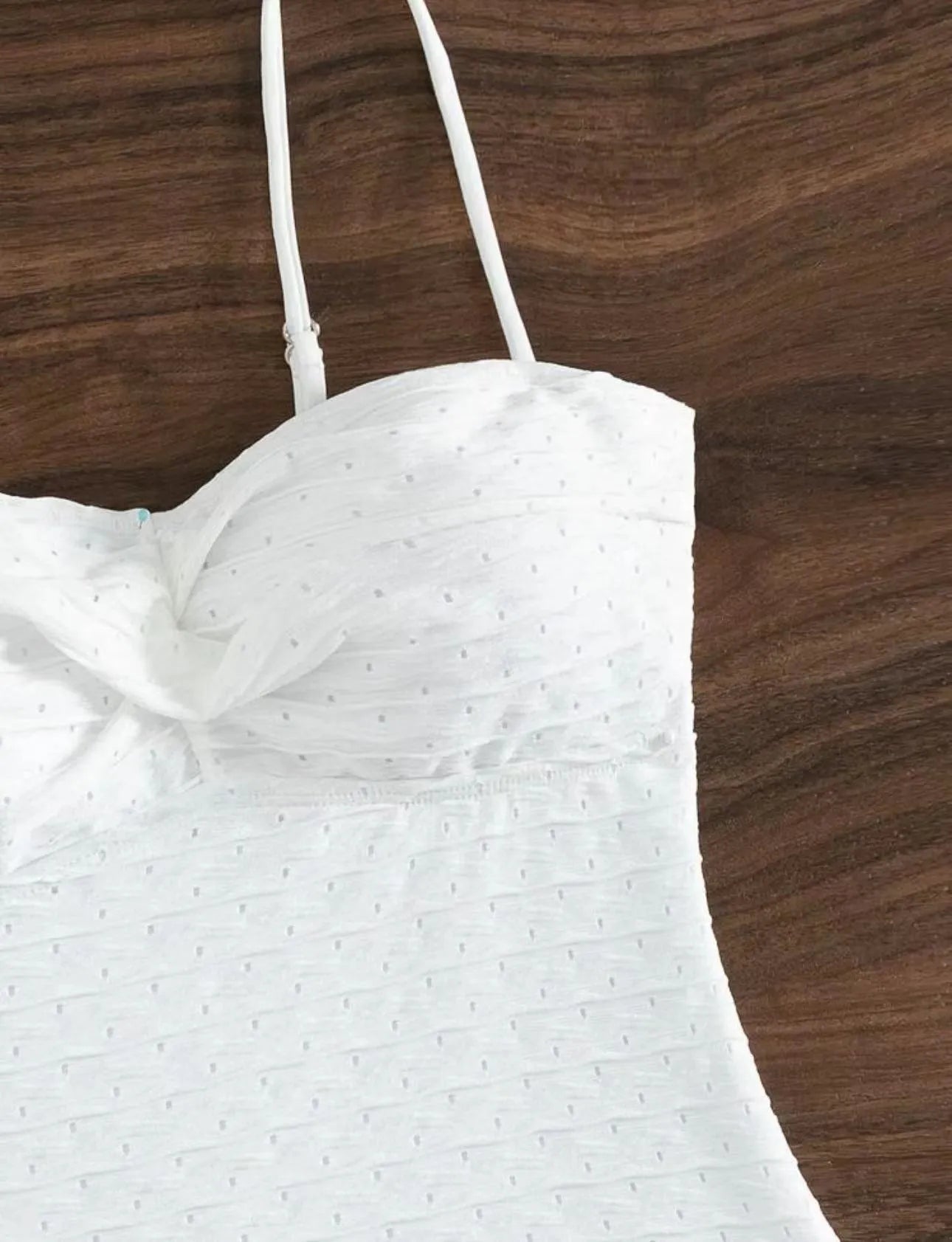 White one-piece sling-back swimsuit for women on a mannequin, showing briefs style.