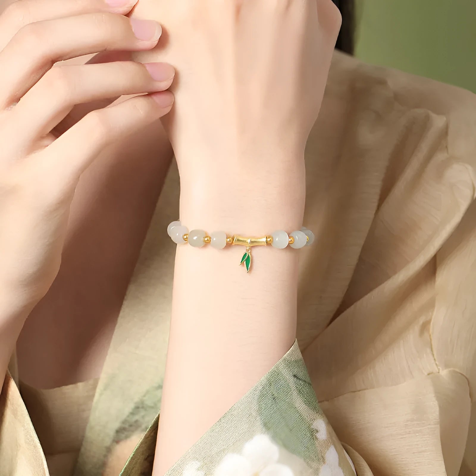 Sterling silver bracelet with gold Hetian jade beads and bamboo leaf charms