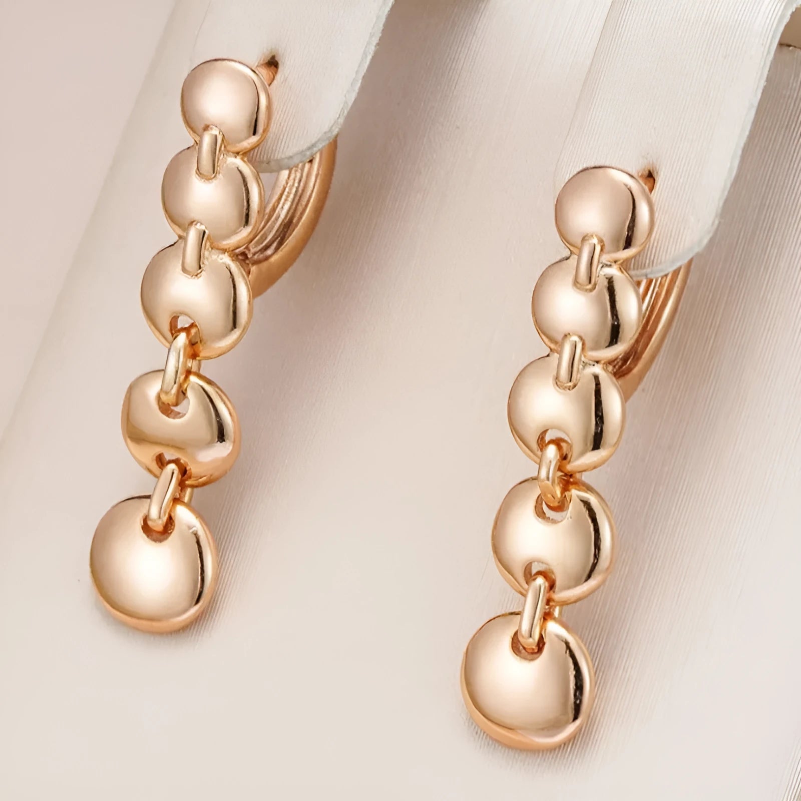 Gold retro long woven copper circle hoop earrings on a white background