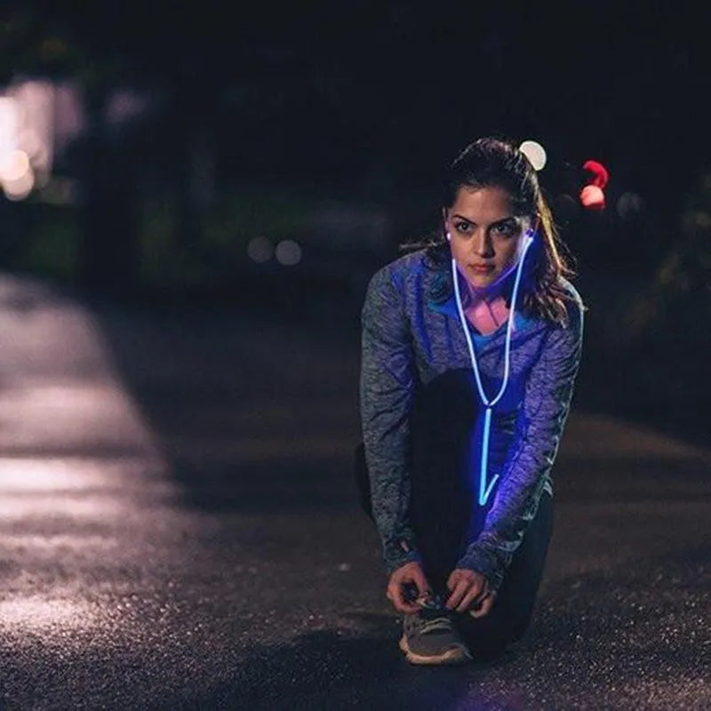 Blue LED light-up earphones with aluminium alloy shells and a 3.5mm plug, showing illuminated EL lines.