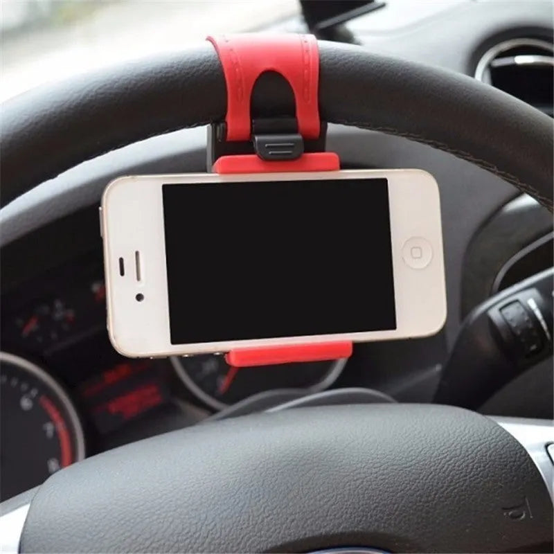 Black universal steering wheel phone holder clip mount attached to a car steering wheel.