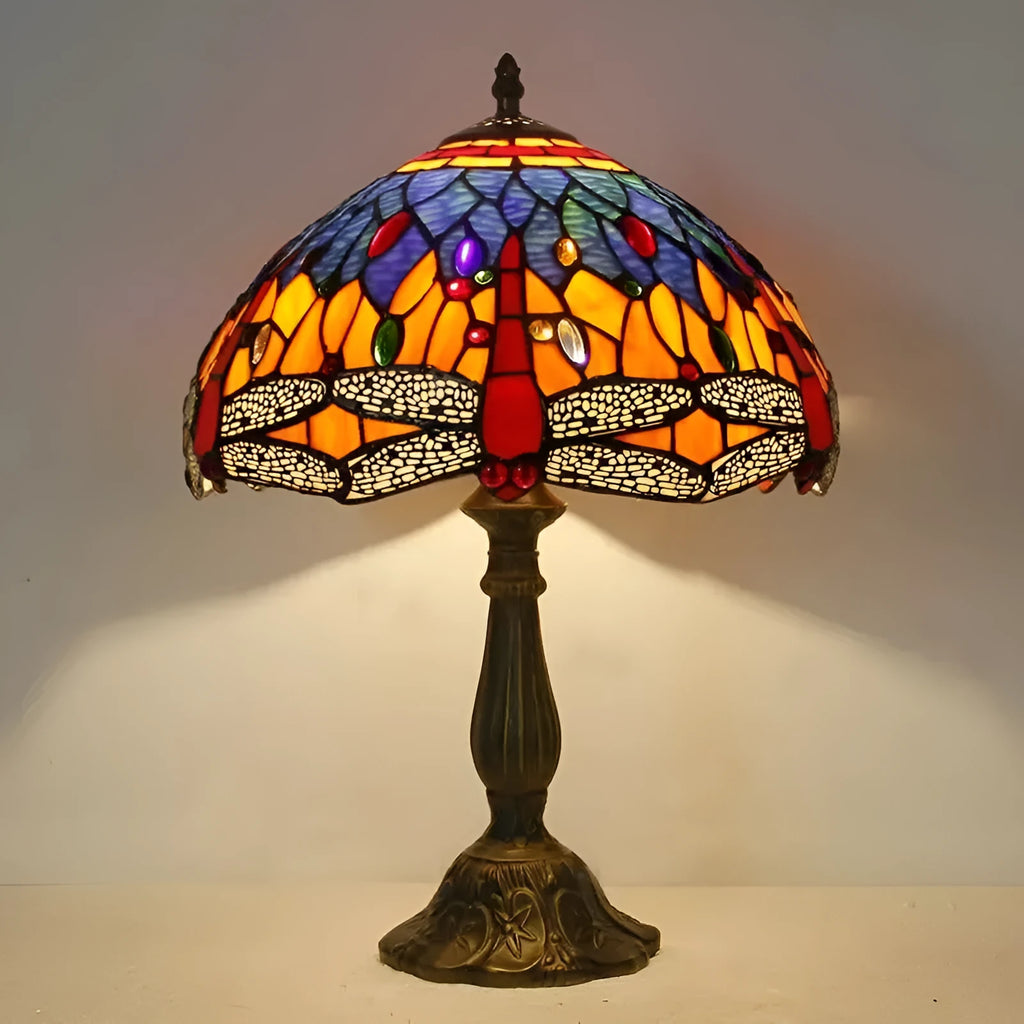 Stone Tiffany dragonfly table lamp in European retro style on a wooden table.