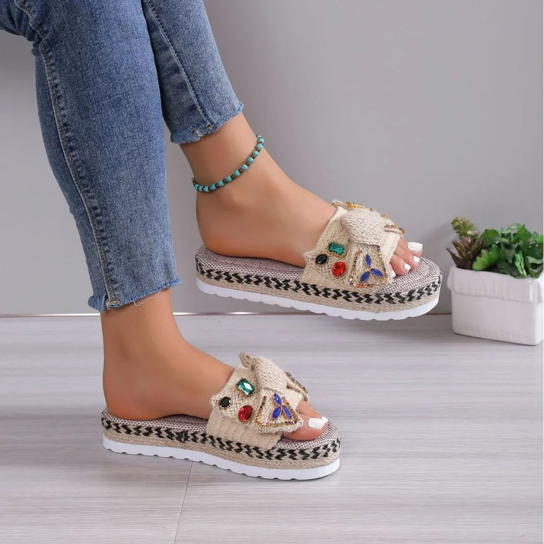 Creamy-white women's platform sandals with beach bow style and cloth construction on model foot