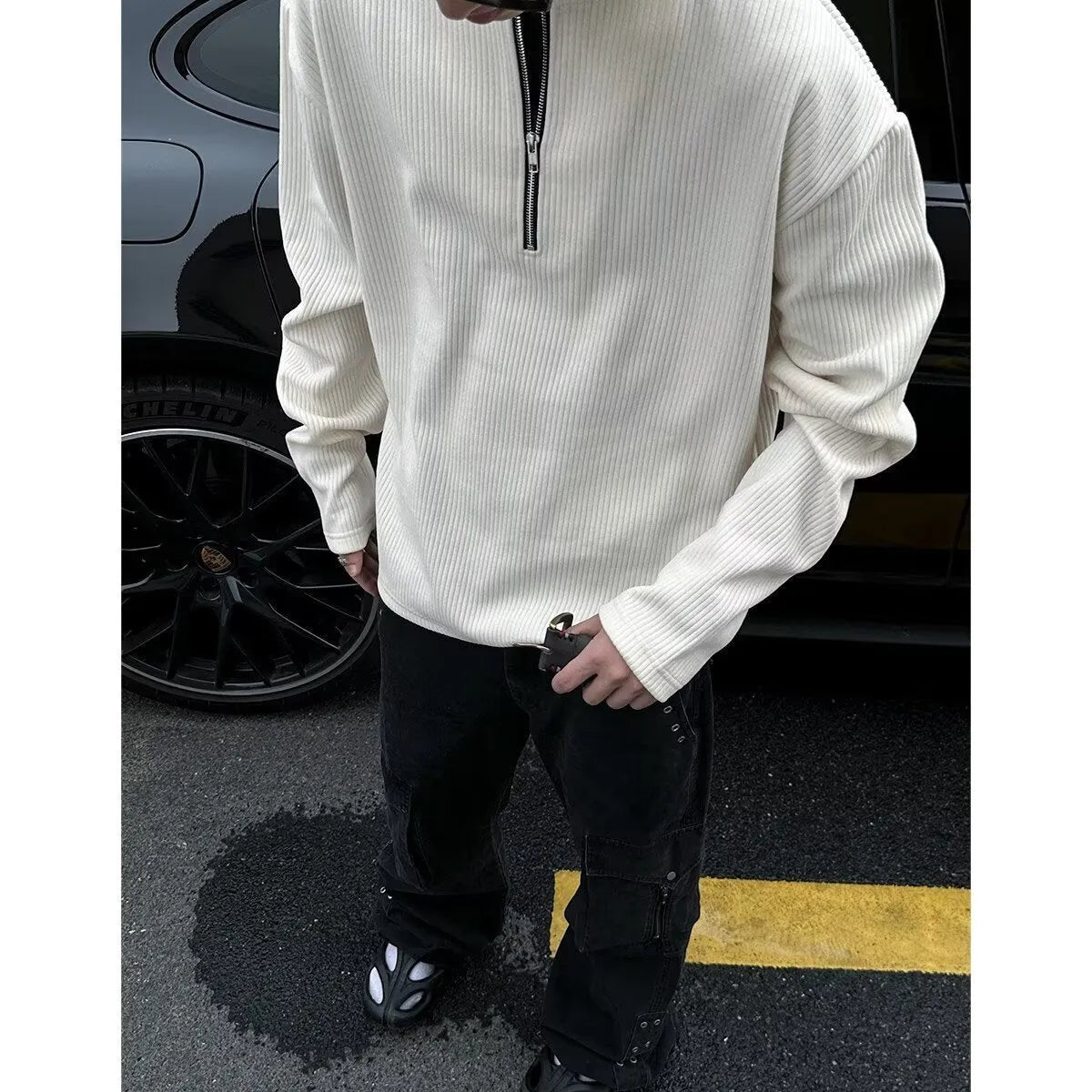 A grey loose-fitting long sleeve women's pullover top hanging flat.