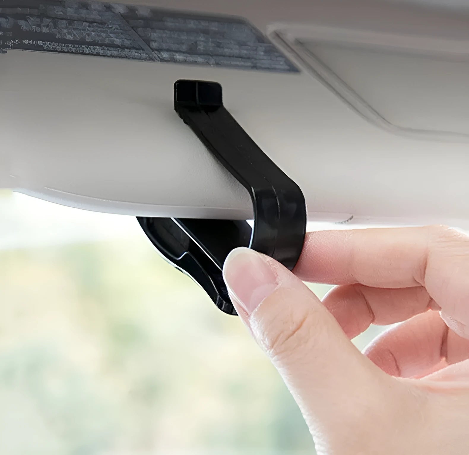 Black plastic car sun visor clip for holding sunglasses, tickets and ID cards.