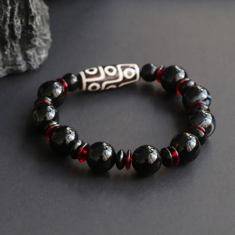 Black agate dzi bead bracelet with 11mm geometric beads in hand-woven construction